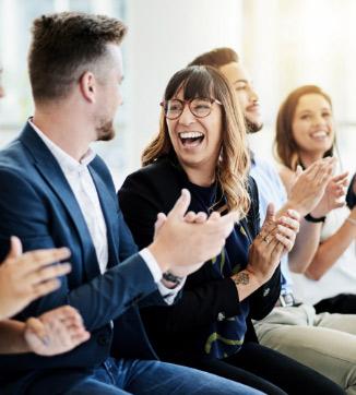 Coworkers clapping and smiling and laughing together