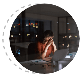 Women in a dark office with her hands on her face